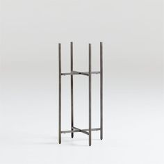 a tall metal stand with three poles on it's sides and one standing in the middle