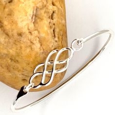 925 Sterling Silver Bangle, Bracelet Celtic Knot Sterling Silver Round Close Bangle, Interweave Bangle ------------------------------------- Details: Bangle Inside- 2.5 Inch X 2 Inch, Celtic Length- 1 1/4 Inch Celtic width- 1/2 inch There could be a fluctuation in the Dimensions. ------------------------------------- Do Visit our Shop for more jewelry: https://www.etsy.com/shop/InsiaJewelry ---------------------------------- Description: All jewelry always unless specified - nickel and lead free Elegant Round Sterling Silver Braided Bracelets, Elegant Braided Bangle Bracelet With Sterling Silver Clasp, Sterling Silver Braided Round Bracelet Gift, Sterling Silver Braided Bracelet Gift, Sterling Silver Round Braided Bracelet, Classic Sterling Silver Braided Bracelet As Gift, Adjustable Braided Bangle Bracelet With Sterling Silver Clasp, Elegant Silver Braided Bracelet, Sterling Silver Braided Bangle Bracelet As Gift