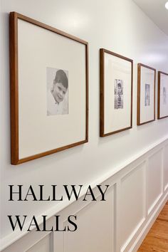 the hallway wall is lined with framed photos and wood flooring, along with white wains