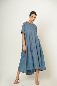 "Introducing our Summer Piece of Sky Blue, Side-Back Gather Dress, meticulously crafted from organic cotton for a luxurious feel with eco-conscious flair. This size inclusive vacation essential boasts a refreshing hue and comfortable modest fit, complemented by thoughtful side and back gathers with convenient pockets and button closure at back. Whether wandering the beach or exploring new destinations, it ensures effortless style and comfort for your summer escapades. Specifications: Length: Front: 44.5\" Back: 50.5'' , Customize it to your preference! Quality: Organic cotton Shipping Details: Ships within 3-5 working days. Need it sooner? Drop us a message for expedited delivery options. Additional Features: Colour: Customize it to your preference! (Pictured: Piece of sky blue) Feel: Soft Summer Cotton Maxi Dress With Natural Dye, Spring Cotton Maxi Dress With Natural Dye, Cotton Dresses With Relaxed Fit, Blue Cotton Maxi Dress With Short Sleeves, Relaxed Fit Cotton Maxi Dress For Daywear, Blue Relaxed Fit Maxi Dress For Daywear, Washed Blue Cotton Dress With Short Sleeves, Summer Indigo Cotton Maxi Dress, Blue Cotton Relaxed Fit Dress