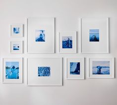 a white wall with many pictures hanging on it