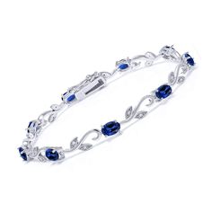 PRICES MAY VARY. Exquisite Greek Vine Design: Elevate your wrist with the exquisite beauty of this tennis bracelet featuring a Greek vine design. Crafted in high-quality 925 sterling silver, the intricate detailing adds a touch of sophistication to the piece. Vibrant Created Sapphire Brilliance: Adorn yourself with the stunning brilliance of created sapphires. The oval 6x4mm gemstones, with a total carat weight of 9.13 Cttw, showcase a deep blue hue, adding a pop of color and elegance to any out Diamonds Jewelry, Fine Jewelry Bracelets, Tennis Bracelet Diamond, Gem Stone, Bracelet For Women, Sparkle Diamonds, Oval Diamond, Tennis Bracelet, Silver Blue