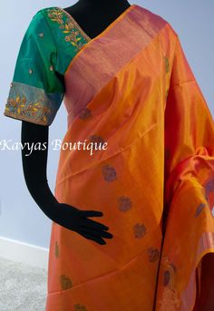 An exquisite Handloom Kanchi Pure Soft Silk Saree in a dual tone Orange and Gold color. The saree features green and blue thread peacock motifs on the body. The border is orange with beautiful peacock motifs. The pallu of the saree is green with heavy gold zari peacock motifs.  Comes with green blouse fabric. Fall and pico done and saree is ready to wear. There is tassels on pallu side of the saree. Condition : New Fabric : Kanchi Pure Soft Silk Saree  Blouse : Green blouse fabric matching pallu. Fall / Pico : Pico on one side and tassels on the other are done. Fall is done too. Washing: Dry clean only Occasion: Traditional, Religious , Festival, Special occasion ** Note ** : This is a handmade saree and slight irregularities, stretches and thread pulls are not considered damages.  *Note: Orange Cotton Silk Blouse Piece With Pallu, Designer Orange Blouse Piece With Zari Weaving, Orange Tussar Silk Traditional Wear With Unstitched Blouse, Orange Blouse With Zari Weaving For Diwali, Orange Blouse With Zari Weaving For Festivals, Multicolor Handloom Kurta For Wedding, Handloom Multicolor Kurta For Weddings, Orange Traditional Wear With Unstitched Paithani Silk Blouse, Orange Self Design Blouse Piece For Designer Wear