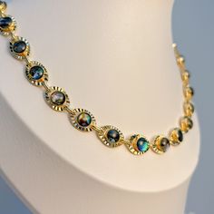 Looking for a new statement piece that'll add a touch of glamour to your outfit? Look no further than our Cleo Necklace featuring stunning green-blue opal. The green-blue opal stones add a touch of elegance and sophistication to this already stunning piece, making it the perfect piece if you're looking for a bolder finish than our white opal Cleo necklace. Our Cleo opal necklace pairs well with both casual and formal attire, making it versatile enough to be worn every day or on special occasions Elegant Round Opal Necklace, Elegant Iridescent Round Jewelry, Elegant Round Iridescent Jewelry, Elegant Opal Clavicle Chain Jewelry, Formal Opal Necklace With 17 Jewels, Elegant Opal Necklaces With Adjustable Chain, Formal Opal Round Necklace, Formal Round Opal Necklace, Elegant Iridescent Gemstone Necklace