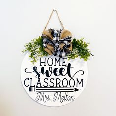 a sign that says home sweet classroom and mrs melon hanging from a wall with a bow on it