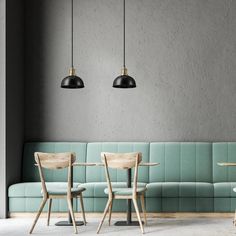 three wooden chairs sitting next to each other in front of a green couch and table