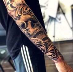 a man with a skull tattoo on his arm