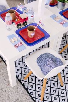 a table set up with plates, cups and napkins for an american flag themed birthday party