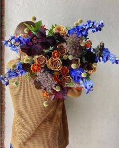 a woman holding a bunch of flowers in her back