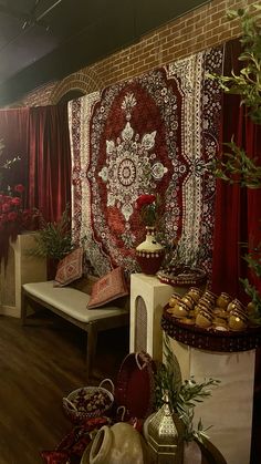 a room filled with lots of different types of pillows and rugs on the wall