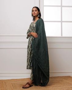 Experience luxury and elegance in our Forest Green Block Printed Suit Set. Crafted from fine mul-mul, this set showcases a classic traditional block print in a deep forest green hue. The set also includes a beautifully complementing dupatta adorned with delicate bead work along its edges. Elevate your wardrobe with this exclusive and timeless piece. No. of pieces - 3 piece set. Color - Green. Fabric - Mul-Mul, Cotton. Washing Instructions - Dry Clean. Festive Green Traditional Drape Pant Set, Festive Green Pant Set With Traditional Drape, Green Cotton Silk Palazzo Set For Diwali, Diwali Green Cotton Silk Palazzo Set, Green Palazzo Set With Printed Motifs, Green Traditional Drape Pant Set For Eid, Traditional Drape Green Pant Set For Eid, Green Kurta With Printed Motifs, Traditional Drape, Designer Green Pant Set With Zari Work