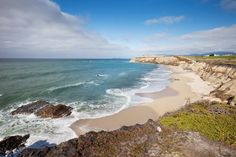 a beach with waves crashing onto the shore