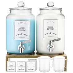 two large jars with handles and lids are sitting on a shelf next to each other