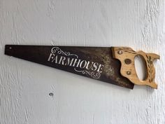 a sign on the wall that says farmhouse with a pair of scissors hanging from it