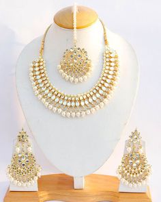 Product Description: * Indian Handmade Kundan Pearls Gold Plated Choker Necklace Earrings Tikka Big Bridal Wedding Fashion Punjabi Pakistani Ethnic Jewelry Set * The base metal color is Gold tone studded with kundan along with beads work on it. * This Jewelry set would add more charms to your beautiful jewelry collection and would surely bring lots of compliments . * Note:- This is an artificial Jewelry Set. * Care Instructions: Keep it dust-free & dirt free in a plastic pouch. Remember to apply White Chandbali Jewelry For Ceremonial Occasions, White Chandbali Ceremonial Jewelry, Bohemian Kundan Necklace With Intricate Design For Wedding, Bohemian Jewelry Sets With Intricate Design For Wedding, Bohemian Chandbali Necklaces For Wedding, Handmade Kundan Chandbali Necklace For Wedding, Handmade Chandbali Kundan Necklace For Wedding, Bohemian Round Chandbalis For Wedding, Heavy Bohemian Chandbalis For Wedding