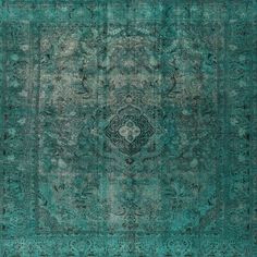 an antique rug with green and blue colors