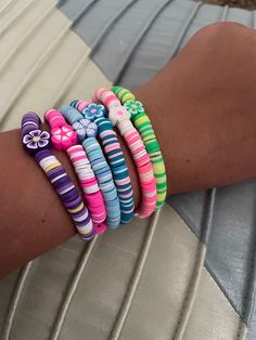 a close up of a person's arm with bracelets on it