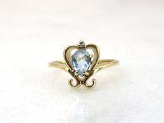 Vintage 14k gold topaz and diamond ring this ring is a US size 5 3/4ths  this ring has a weight of 2.48 grams you can find the gold mark on the inner band the face of the ring measures 11.5mm x 8.7mm the topaz measures 6mm x 4.2mm and is a pear cut the diamonds measure 1.4mm  the band measures 1.8mm at its thickest part and tapers down to 1.3mm at the back of the ring PLEASE BE ADVISED SOME PHOTOS ARE CLOSEUPS TO SHOW DETAIL, PLEASE READ FULL DESCRIPTION FOR BETTER UNDERSTANDING OF SIZE.  This i Topaz And Diamond Ring, Gold Topaz, All Gems, Vintage Ring, Pear Cut, Rings Statement, Precious Metals, Vintage Rings, Statement Rings