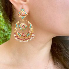 This gold plated silver chandbali earrings feature firoza, pearls and synthetic red stones to create a timeless aesthetic. The earrings are decorated with high-grade pearls, turquoises and rubies to craft an intricate, special design. The earrings come with a bombay screw closure. All of Rudradhan's Gold Plated Jewellery is made using 925 Silver, real freshwater pearls and high quality ruby, emerald and sapphire beads. The default choice for studded stones used is synthetic that closely resemble Turquoise Temple Jewelry Earrings For Festivals, Turquoise Meenakari Temple Jewelry Earrings, Elegant Turquoise Kundan Earrings, Turquoise Chandbali Jewelry With Latkans, Traditional Turquoise Earrings For Diwali, Festive Turquoise Chandbali Jewelry, Festive Turquoise Temple Jewelry Earrings, Turquoise Chandbali Earrings Bollywood Style, Turquoise Chandbali Earrings For Diwali