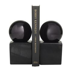 a bookend with two black balls on it