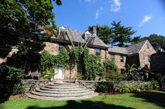 an old brick house with stone steps leading up to it