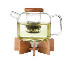 a glass tea pot filled with green tea