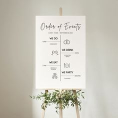 a sign that says order of events on top of a wooden easel with greenery