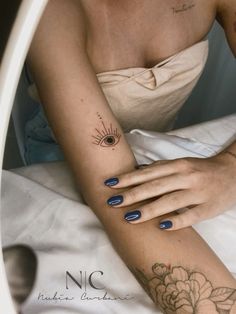 a woman's arm with a tattoo on it and a flower in the middle