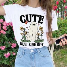 Cute but Creepy Ghost Tshirt, Retro Halloween Tee, Boo Halloween Spooky Shirts, Creepy Halloween Tee, Funny Halloween Gift Tee, UNISEX Who can resist this aesthetic retro ghost Halloween T-shirt? The quote on the tee reads 'Cute but creepy'.  It's comfy and soft and would make a perfect gift for a loved one, or for anyone who loves a funny tee or Halloween. The UNISEX shirt and available in multiple colours and sizes.  *MADE TO ORDER ITEM* - -FEATURES - - - Available in multiple colours and size White Grunge T-shirt For Fall, Halloween Trendy Crew Neck Top, Trendy Halloween Crew Neck Top, Casual Halloween Graphic Print Top, Funny Halloween Tops With Skull Print, Cute Halloween Streetwear Tops, Funny Halloween Top With Skull Print, Funny Halloween Skull Print Top, Funny Skull Print Tops For Halloween