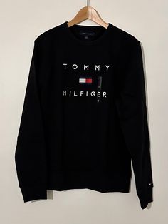 Tommy Hilfiger Stacked EMB Crewneck Black 78J9708 001 Tommy Hilfiger Black Crew Neck Top, Classic Black Tommy Hilfiger Top, Tommy Hilfiger Black Long Sleeve Top, Tommy Hilfiger Black Tops For Fall, Black Tommy Hilfiger Tops For Fall, Tommy Hilfiger, Crew Neck, Black