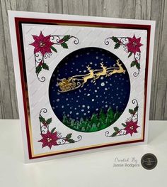 a christmas card with a santa sleigh on it and poinsettis