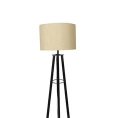 a black and white floor lamp with a beige shade