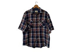 "80's Sears Vintage Flannel Short Sleeve Acrylic Shirt with Pockets Blue Brown Burgundy White Plaid Men's Large ☆ SIZE: Men's Large ☆ MEASUREMENTS (inches, item lying flat): ✄ Length: 29\" ✄ Width (armpit to armpit): 25\" ✄ Arms (armpit seam to cuff): 8 1/2\" ☆ COLOR: Blue, Burgundy, White, Orange ☆ MATERIAL: Unknown, feels like acrylic ☆ BRAND: Sears ☆ CONDITION: The item is vintage and previously loved.  There is no visible damage to the item. Thanks for checking out this listing! Be sure to v Affordable Vintage Flannel Shirt With Buttons, Cheap Vintage Plaid Flannel Shirt, Vintage Blue Flannel Shirt, Short Sleeve Flannel, Flannel Shorts, Vintage Flannel, Orange Material, Unique Items, Pick One