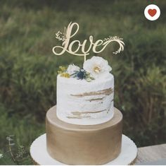 a wedding cake sitting on top of a wooden table