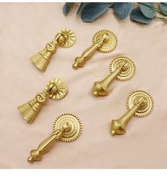 brass door handles and knobs on a pink background