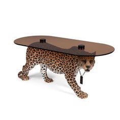 a cheetah table with a glass top on it