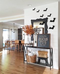 a living room filled with furniture and lots of bats hanging on the wall above it