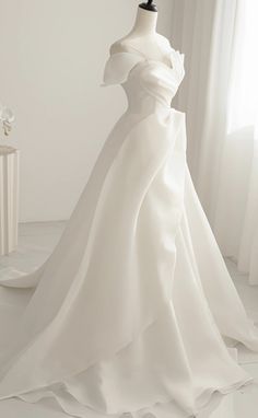 a white wedding dress on a mannequin