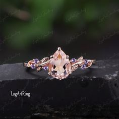 a ring with an oval cut morganite surrounded by purple and white stones on top