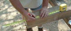 a man is measuring the height of a piece of wood with a tape measure ruler