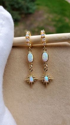 Starburst Opal Earrings  Gold huggie earrings with beautiful shine and a great celestial vibe.  Earrings: ~ 14k Gold Plated ~ With Opal Accents (the opals are synthetic man-made) 👉 Link to Our STOREFRONT: https://www.etsy.com/shop/FashionCrashJewelry?ref=shopsection_shophome_leftnav&ga_search_query=crystal%2Bnecklace Our Motto ~ Happy Customers Are Awesome 🌞Let us know of any problems or concerns with purchases. 🌞 5star reviews and positive comments are greatly appreciated, they help the succ White Celestial Round Earrings, Celestial White Round Earrings, White Celestial Star Earrings, Celestial White Star Earrings, White Sparkling Hoop Earrings As Gift, White Sparkling Hoop Earrings For Gift, Sparkling White Hoop Earrings As Gift, Celestial White Earrings, White Celestial Earrings For Gift