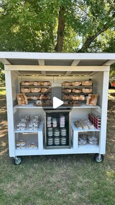 an outdoor food cart is shown with shelves full of food and containers on the outside