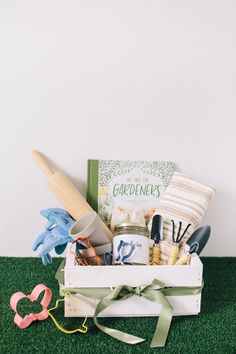 the garden gift box is filled with gardening tools and other crafting supplies, such as scissors