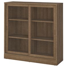 a wooden bookcase with three shelves on one side and two doors on the other