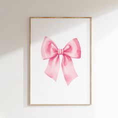 a pink bow is hanging on the wall