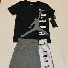 Jordan Bot's 2pc Set . Brand New With Tag . Set : Jordan Black Short Sleeve T-Shirt And Jordan Jumpman Logo. Top Is 100% Cotton. Jordan Short's Gray White With Air Jordan On It. Short's Is 60% Cotton 40% Polyester . Size 6 . Brand New With Tag . Casual Cotton Sets With Logo Print, Gray Sporty Tops For Playwear, Black Short Sleeve T-shirt For Play, Casual Gray Set With Letter Print, Casual Gray Letter Print Set, Gray Casual Short Sleeve Sets, Casual Gray Short Sleeve Sets, Gray Short Sleeve Casual Sets, Black T-shirt With Graphic Print For Casual Wear