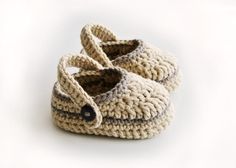 a pair of crocheted baby shoes sitting on top of each other