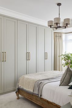 a bedroom with white walls and beige carpeted flooring is pictured in this image