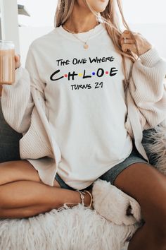 a woman sitting on top of a couch wearing a white shirt that says the one where chloe turns 21