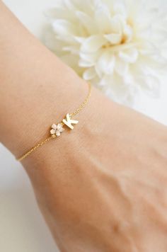 Super Dainty Personalized Cherry Blossom initial bracelet.▶ Material - Gold plated over brass▶ Chain Length - 5 ~ 9 inches adjustable▶ Measure - Flower 6mm  Letter H 7mm x W. 5mm▶The matching necklace available from following link.https://www.etsy.com/listing/558720665/personalized-cherry-blossom-initia▶The matching earrings available from following link.https://www.etsy.com/listing/558720665/personalized-cherry-blossom-initial▶ The jewelry comes in a gift box** Please check the shop policy for Flower Girl Bracelet, Dainty Name Bracelet For Bridesmaid Gift, Dainty Flower Shaped Personalized Bracelets, Delicate Personalized Name Bracelet As A Gift, Personalized Delicate Name Bracelet As A Gift, Delicate Personalized Name Bracelet As Gift, Delicate Personalized Name Bracelet For Gift, Dainty Name Bracelet With Initials As Gift, Dainty Initials Name Bracelet For Gift